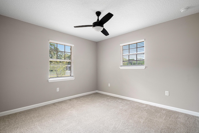 207 Oglesby Ave, Crestview, FL 32536 - spare room featuring plenty of natural light, carpet flooring, a ceiling fan, a textured ceiling, and a smoke detector
