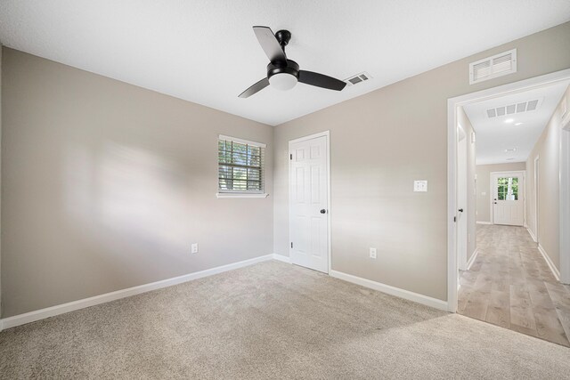 207 Oglesby Ave, Crestview, FL 32536 - unfurnished bedroom featuring light carpet, ceiling fan, and a closet