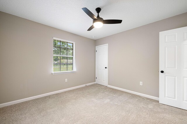 207 Oglesby Ave, Crestview, FL 32536 - unfurnished bedroom featuring light colored carpet, ceiling fan, and a textured ceiling