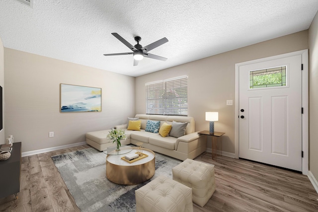 207 Oglesby Ave, Crestview, FL 32536 - living room featuring a ceiling fan, wood finished floors, and a textured ceiling