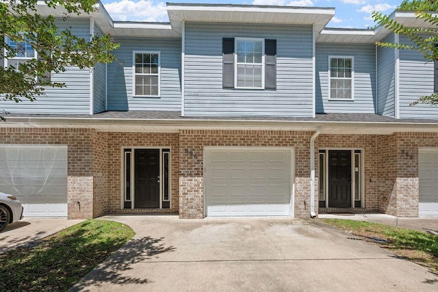 996 Leigh Ann Ln, Fort Walton Beach, FL 32547 - townhome / multi-family property featuring driveway, a garage, and brick siding