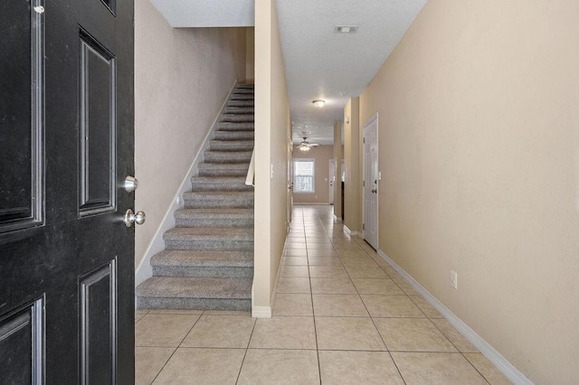 996 Leigh Ann Ln, Fort Walton Beach, FL 32547 - stairs with tile patterned floors, baseboards, and a ceiling fan