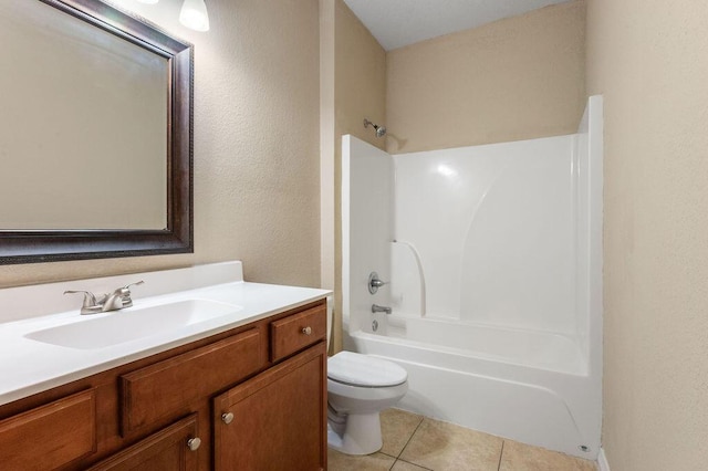 996 Leigh Ann Ln, Fort Walton Beach, FL 32547 - full bathroom with tile patterned floors, vanity, toilet,  shower combination, and a textured wall