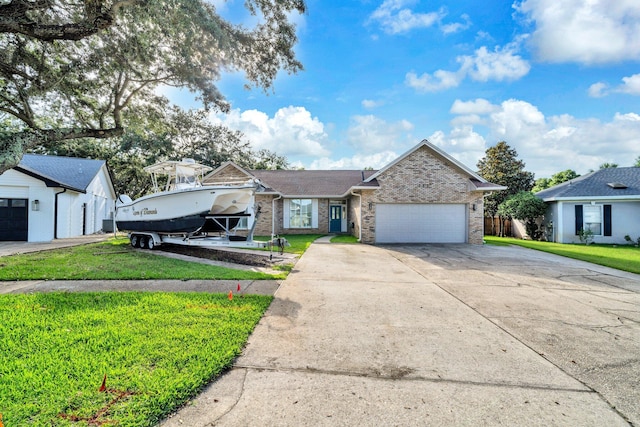 283 Stahlman Ave, Destin, FL 32541 - view of front of house with brick siding, a front yard, a garage, and concrete driveway