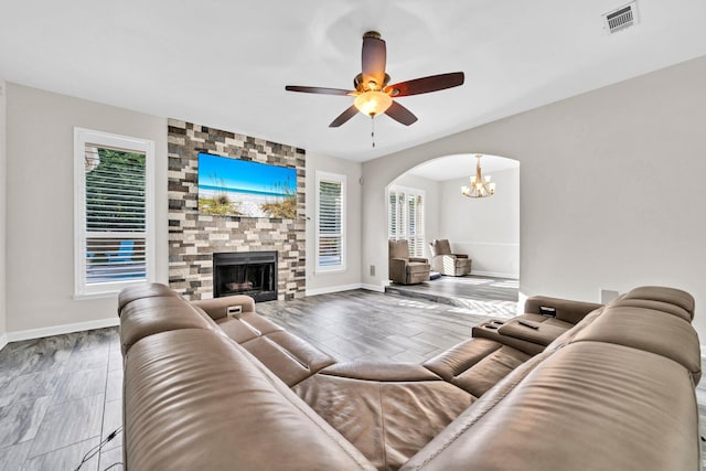 283 Stahlman Ave, Destin, FL 32541 - living area featuring arched walkways, baseboards, a ceiling fan, and a large fireplace