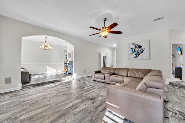 283 Stahlman Ave, Destin, FL 32541 - living area with arched walkways, ceiling fan, baseboards, a chandelier, and wood finished floors