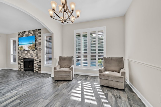 283 Stahlman Ave, Destin, FL 32541 - sitting room with a chandelier, arched walkways, baseboards, and a fireplace
