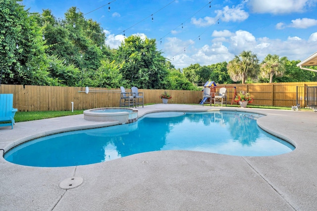 283 Stahlman Ave, Destin, FL 32541 - view of pool with a playground, a fenced backyard, a patio, a pool with connected hot tub, and view of wooded area