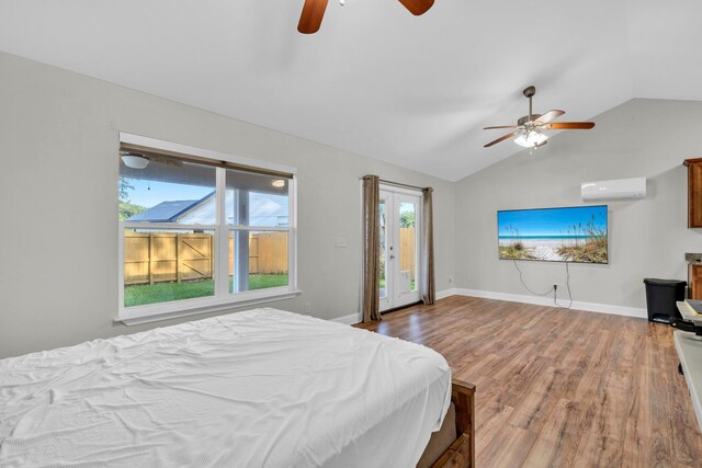 283 Stahlman Ave, Destin, FL 32541 - bedroom featuring a wall mounted air conditioner, vaulted ceiling, wood finished floors, access to exterior, and a ceiling fan