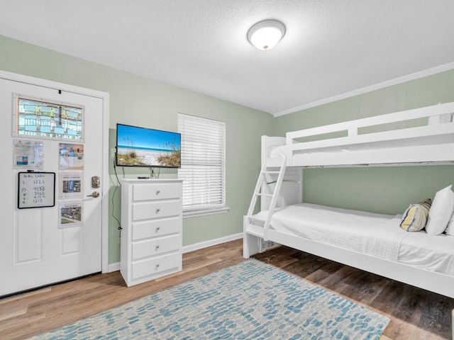 50 Gossamer Ln Unit 10, Inlet Beach, FL 32461 - bedroom with wood finished floors, multiple windows, baseboards, and a textured ceiling