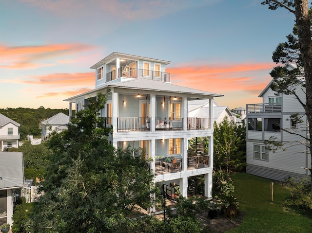 51 Grande Pointe Dr, Inlet Beach, FL 32461 - back of house featuring a balcony, metal roof, and a lawn