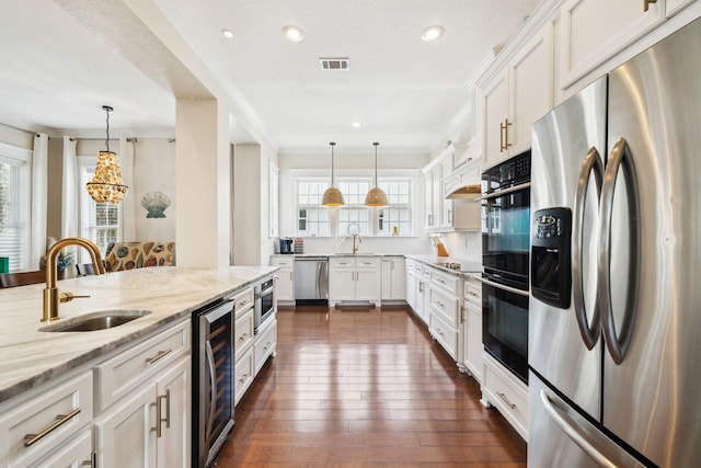 51 Grande Pointe Dr, Inlet Beach, FL 32461 - kitchen with black appliances, a sink, wine cooler, plenty of natural light, and recessed lighting