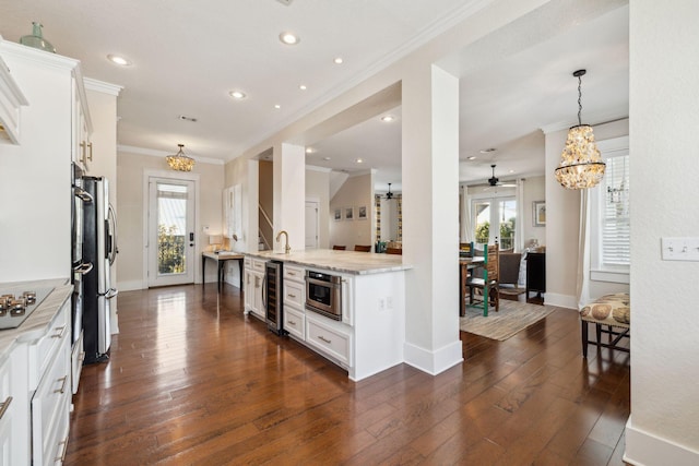 51 Grande Pointe Dr, Inlet Beach, FL 32461 - kitchen featuring wine cooler, ornamental molding, baseboards, plenty of natural light, and white cabinets