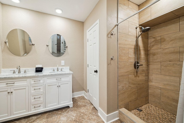 51 Grande Pointe Dr, Inlet Beach, FL 32461 - bathroom with double vanity, tiled shower, and baseboards