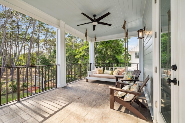 51 Grande Pointe Dr, Inlet Beach, FL 32461 - sunroom with ceiling fan, view of wooded area, and an outdoor hangout area