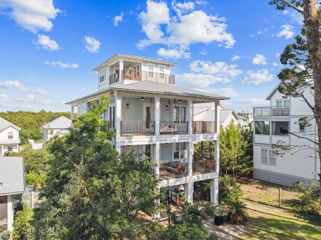 51 Grande Pointe Dr, Inlet Beach, FL 32461 - raised beach house featuring a balcony, metal roof, ceiling fan, and covered porch