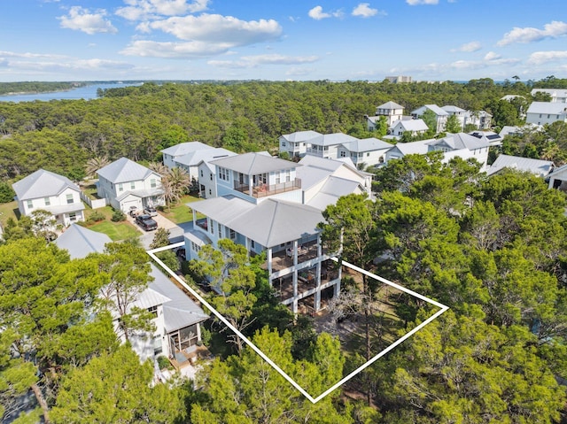 51 Grande Pointe Dr, Inlet Beach, FL 32461 - aerial view of residential area with property parcel outlined, a heavily wooded area, and a large body of water