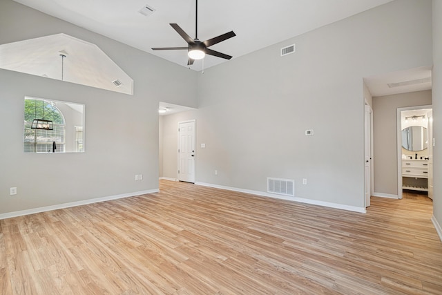 28 6th St, Shalimar, FL 32579 - spare room with light wood-style flooring, ceiling fan, baseboards, and high vaulted ceiling