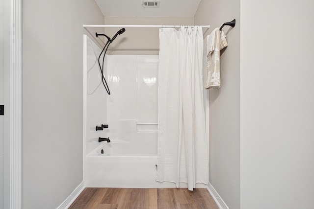 28 6th St, Shalimar, FL 32579 - bathroom with wood finished floors, shower / bath combo with shower curtain, and baseboards