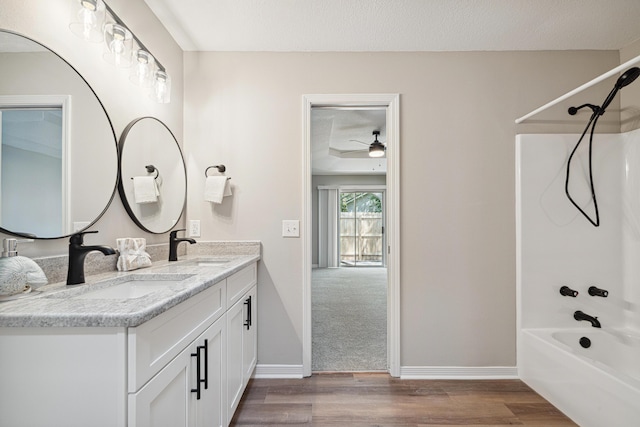 28 6th St, Shalimar, FL 32579 - full bath featuring shower / washtub combination, double vanity, wood finished floors, and baseboards