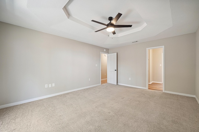28 6th St, Shalimar, FL 32579 - unfurnished bedroom featuring carpet, a tray ceiling, and baseboards