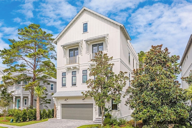 LOT36 Grande Pointe Cir, Inlet Beach, FL 32461 - view of front facade featuring a garage, board and batten siding, driveway, a balcony, and french doors