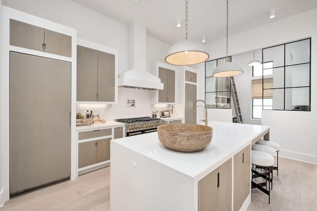 LOT36 Grande Pointe Cir, Inlet Beach, FL 32461 - kitchen featuring gas range, a kitchen island with sink, light wood-style flooring, and custom range hood