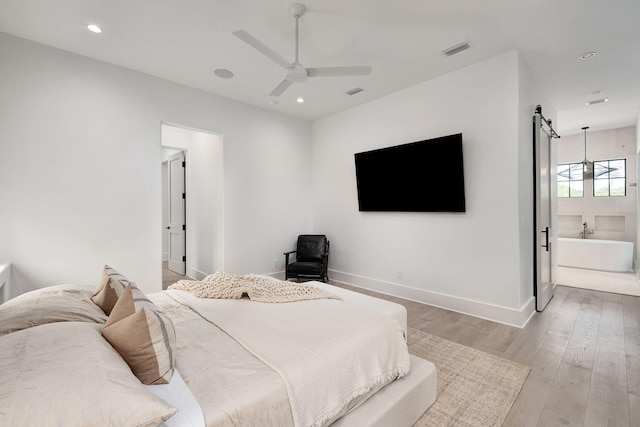 LOT36 Grande Pointe Cir, Inlet Beach, FL 32461 - bedroom with a barn door, light wood-style flooring, baseboards, recessed lighting, and connected bathroom