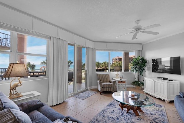 50 Surf Song Ln Unit 312D, Miramar Beach, FL 32550 - living room featuring light tile patterned floors, healthy amount of natural light, a ceiling fan, and ornamental molding