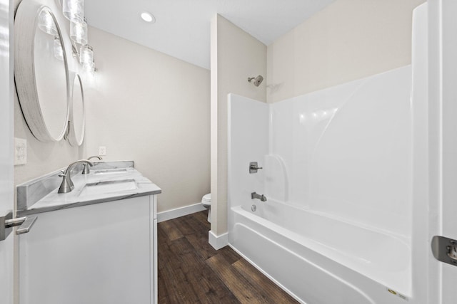 1354 Georgia Ave, Baker, FL 32531 - full bathroom with toilet, double vanity, baseboards, wood finished floors, and shower / washtub combination