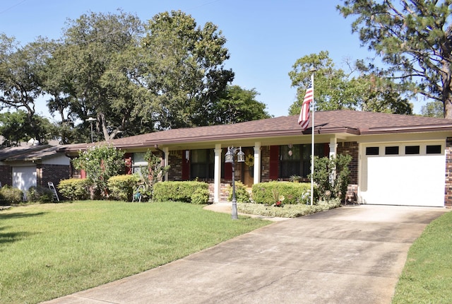 22 10th St, Shalimar, FL 32579 - ranch-style house with concrete driveway, a front yard, a garage, and brick siding
