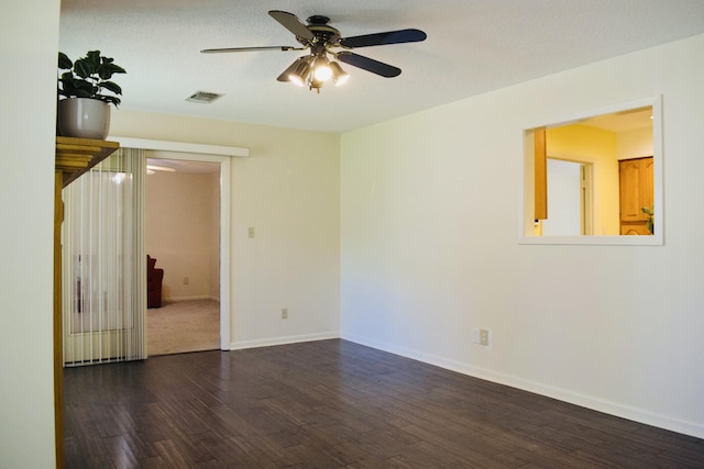 22 10th St, Shalimar, FL 32579 - spare room featuring dark wood-style flooring, ceiling fan, and baseboards