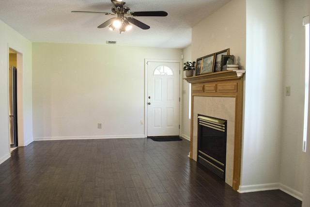 22 10th St, Shalimar, FL 32579 - unfurnished living room featuring dark wood-style floors, ceiling fan, a tiled fireplace, and baseboards