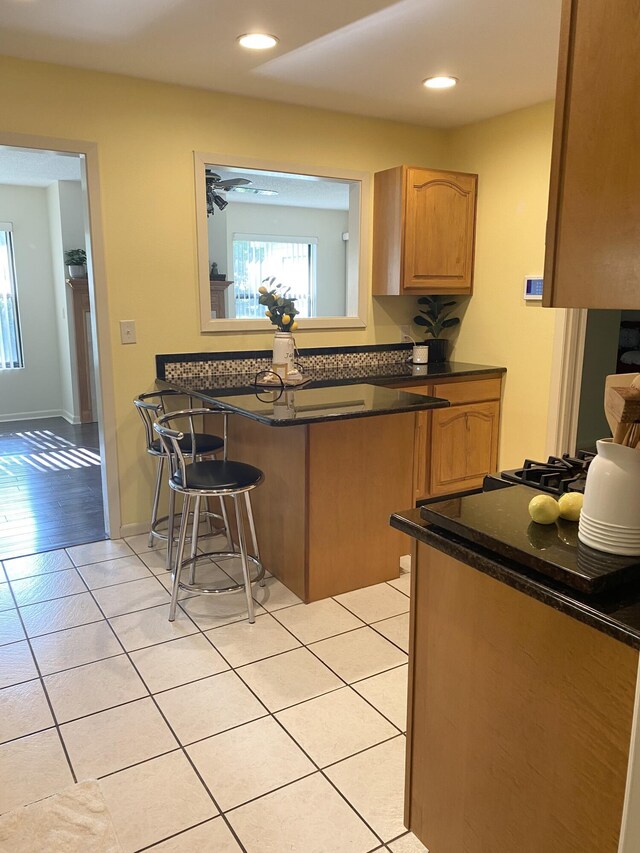 22 10th St, Shalimar, FL 32579 - kitchen featuring dark countertops, plenty of natural light, light tile patterned floors, and recessed lighting