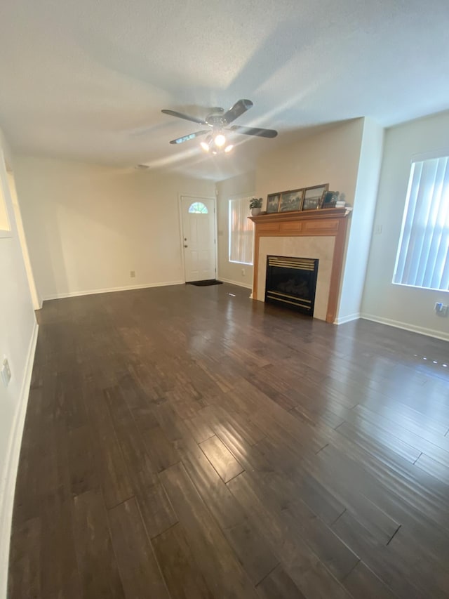 22 10th St, Shalimar, FL 32579 - unfurnished living room with dark wood-type flooring, a ceiling fan, a fireplace, and baseboards
