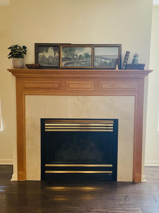 22 10th St, Shalimar, FL 32579 - detailed view of a tile fireplace, wood finished floors, and baseboards
