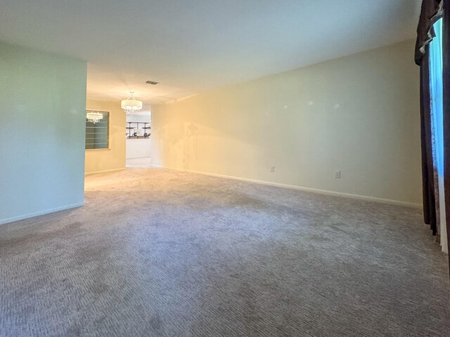 22 10th St, Shalimar, FL 32579 - unfurnished living room with a chandelier, carpet floors, and baseboards