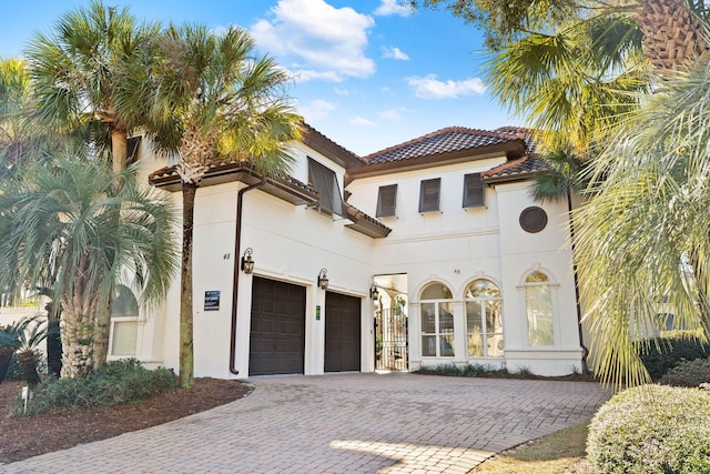 48 Tranquility Ln, Destin, FL 32541 - mediterranean / spanish house with a tiled roof, stucco siding, and decorative driveway