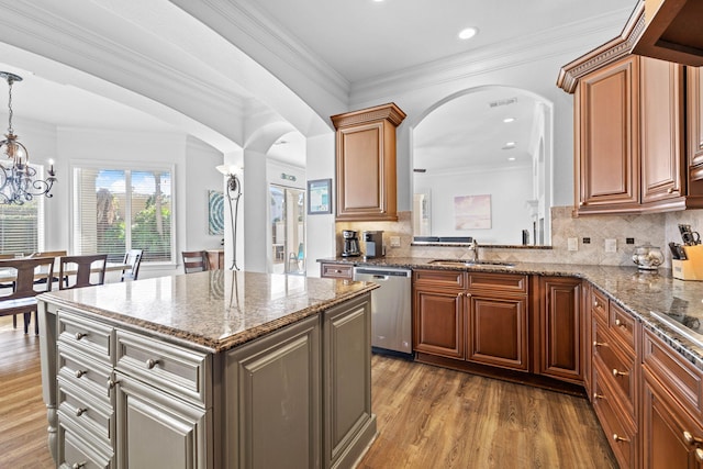 48 Tranquility Ln, Destin, FL 32541 - kitchen with dishwasher, a sink, arched walkways, wood finished floors, and stone countertops