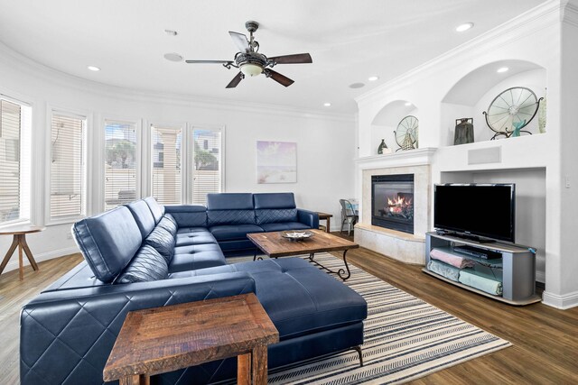 48 Tranquility Ln, Destin, FL 32541 - living area with ornamental molding, a ceiling fan, a glass covered fireplace, wood finished floors, and baseboards