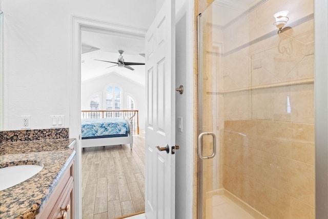 48 Tranquility Ln, Destin, FL 32541 - bathroom featuring connected bathroom, a stall shower, lofted ceiling, wood finished floors, and vanity