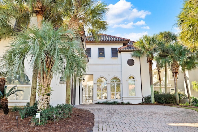 48 Tranquility Ln, Destin, FL 32541 - property entrance featuring a tiled roof, stucco siding, and a gate