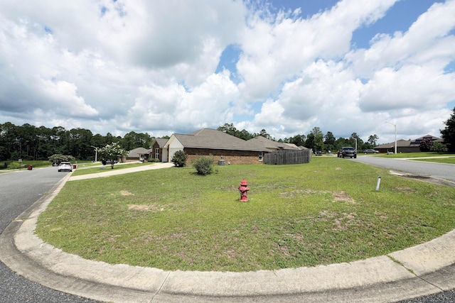 415 Scooter Cv, Crestview, FL 32539 - view of side of property with driveway, a yard, and a garage