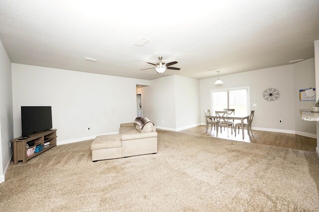 415 Scooter Cv, Crestview, FL 32539 - living room featuring carpet floors, baseboards, and a ceiling fan