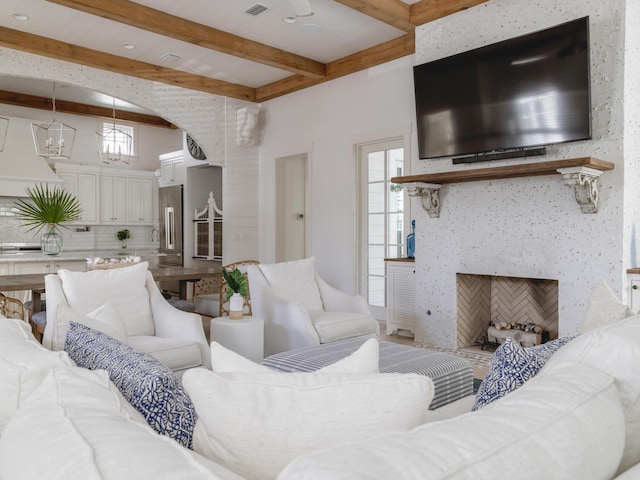 44 Tidepool Ln, Watersound, FL 32461 - living area featuring beam ceiling and a fireplace