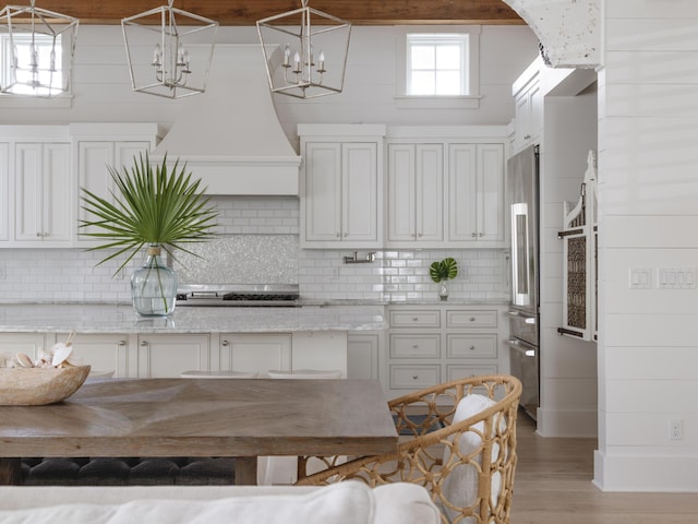 44 Tidepool Ln, Watersound, FL 32461 - kitchen featuring high quality fridge, light wood-style flooring, white cabinetry, and backsplash