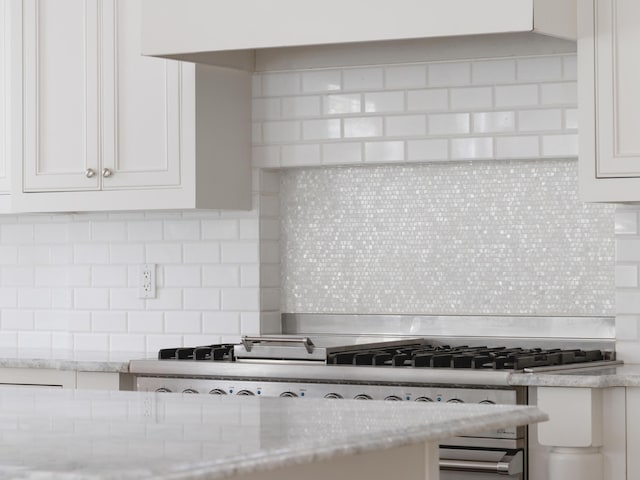 44 Tidepool Ln, Watersound, FL 32461 - kitchen with tasteful backsplash, white cabinetry, and light stone counters