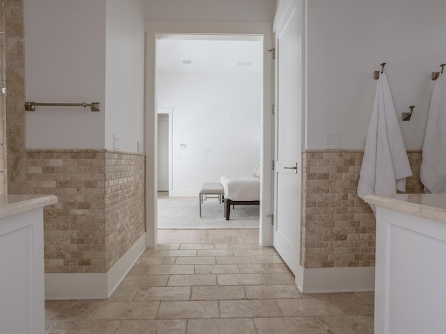 44 Tidepool Ln, Watersound, FL 32461 - bathroom featuring tile walls and a wainscoted wall