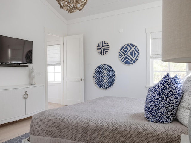 44 Tidepool Ln, Watersound, FL 32461 - bedroom featuring vaulted ceiling, wood finished floors, and a chandelier
