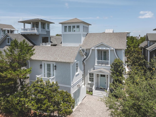 44 Tidepool Ln, Watersound, FL 32461 - view of front of house featuring a shingled roof, a balcony, driveway, and a garage